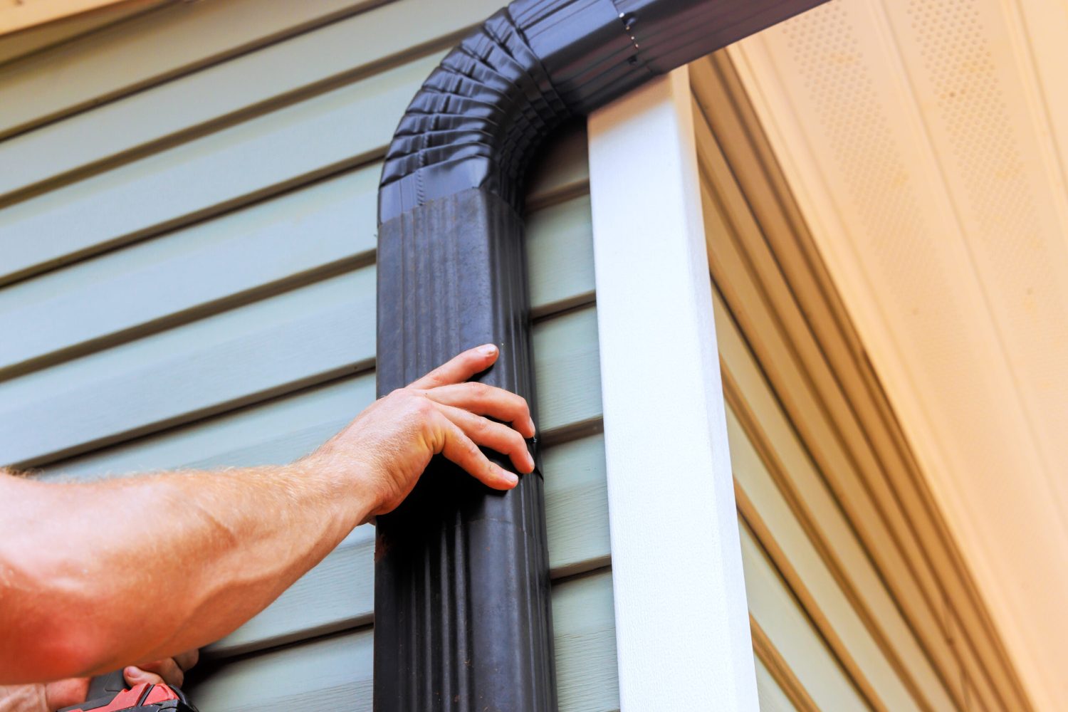 on-roof-worker-is-installing-rain-gutter-fitting-2024-08-14-23-59-23-utc-1-scaled.jpg